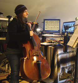 Doris Bartha with her cello in a Seattle area recording studio working on a music composition in Finale